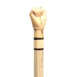 A 19th CENTURY WHALEBONE AND MARINE IVORY WALKING CANE having a carved fist handle on a chamfered
