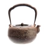 A 19th CENTURY JAPANESE CAST IRON TEAPOT AND COVER of squat form with surmounted swing handle,