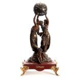 A LATE 19th CENTURY FRENCH FIGURAL MANTEL CLOCK RAISED ON A ROUGE MARBLE BASE the two patinated