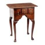 AN EARLY 18TH CENTURY MINIATURE OAK LOWBOY with re-entrant corners, above three small drawers,