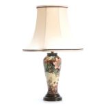 A MODERN MOORCROFT TABLE LAMP with colourful tube lined flower decoration 47cn high to top of the