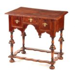 A WILLIAM AND MARY HERRING-BANDED FIGURED WALNUT SIDE TABLE with a quarter veneered cross-banded