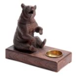 A LATE 19TH CENTURY SWISS CARVED BEAR MUSICAL CIGAR BOX with hinged compartment and brass match