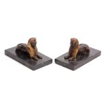 A PAIR OF LATE 19TH CENTURY REGENCY STYLE BRONZE AND GILT BRONZE SPHINX BOOKENDS mounted on black