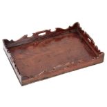A GEORGE III FIGURED MAHOGANY RECTANGULAR TRAY with shaped gallery and cutout side handles 58cm wide
