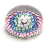 A 19TH CENTURY STOURBRIDGE MILLEFIORI GLASS PAPERWEIGHT filled with bands of pink, blue, green and