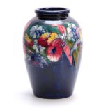 A LARGE 20TH CENTURY MOORCROFT BULBOUS VASE decorated with Orchids - signed underneath W.