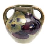 A WILLIAM MOORCROFT BURSLEM CELADON GROUND SMALL TWO-HANDLED BULBOUS VASE with leaf spray and