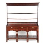 AN EARLY 18TH CENTURY JOINED OAK SILHOUETTE POT BOARD DRESSER AND RACK with moulded cornice above