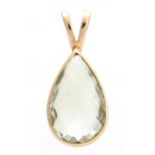 A YELLOW GOLD MOUNTED TEARDROP SHAPED PENDANT set with a large facet-cut clear semi-precious stone