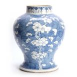 A 19TH CENTURY CHINESE BULBOUS VASE DECORATED WITH PRUNUS BLOSSOM 34cm high.