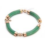 AN ORIENTAL 14K YELLOW GOLD AND JADEITE BRACELET of four sections with Oriental cypher adjoining