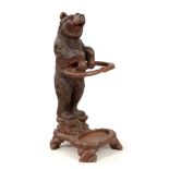 A LATE 19TH CENTURY SWISS CARVED BLACK FOREST BEAR STICK STAND with a large bear having glass eyes