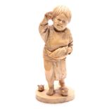 A JAPANESE MEIJI PERIOD CARVED IVORY OKIMONO OF A YOUNG BOY PLAYING WITH BIRDS signed with character