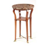 AN ARTS AND CRAFTS OCCASIONAL TABLE having a circular marble top supported on square tapering oak
