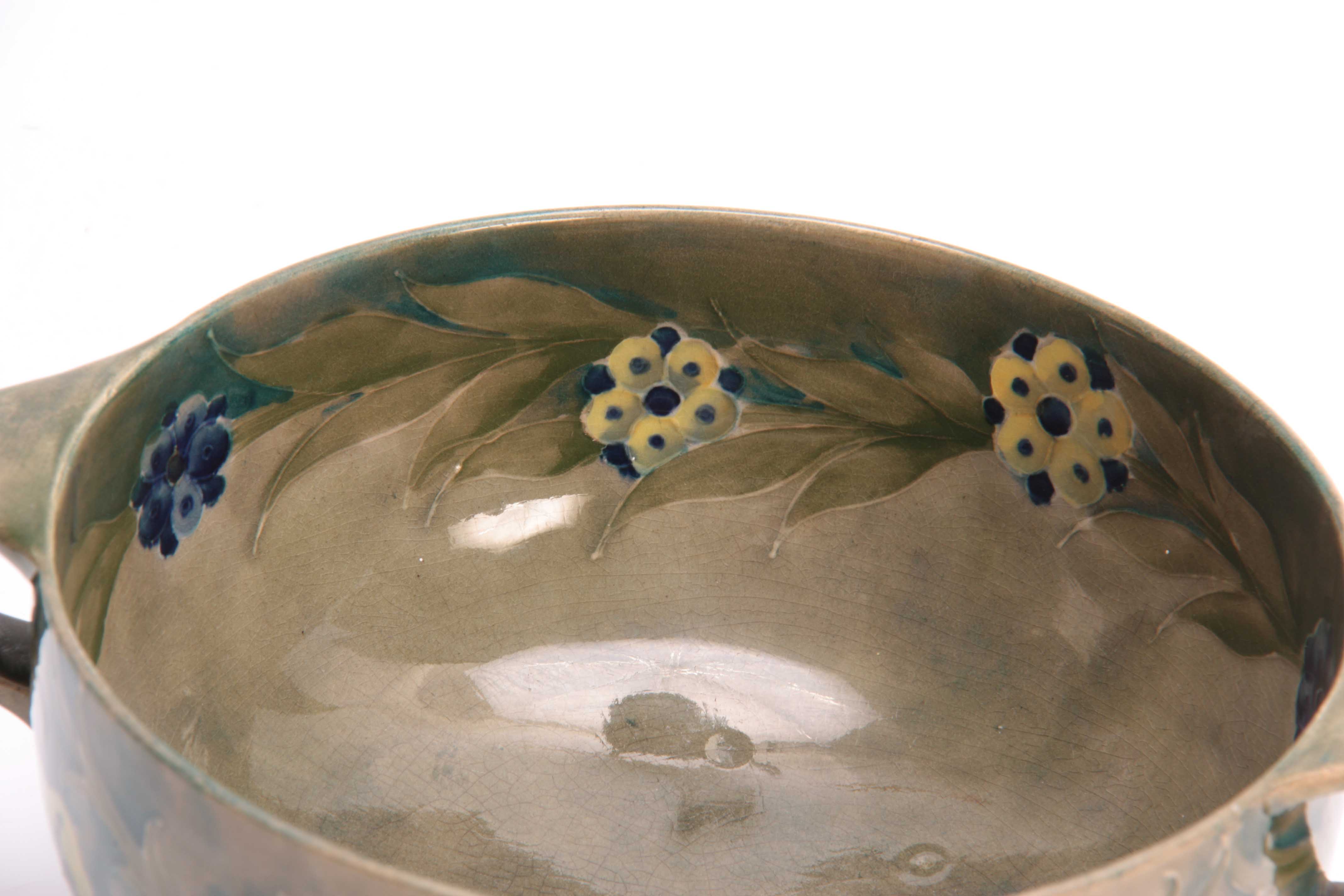 A WILLIAM MOORCROFT BURSLEM FOOTED TWO-HANDLED BOWL with flowerhead and leaf spray decoration on a - Image 2 of 3