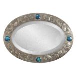 A LATE 19th CENTURY LIBERTY PEWTER OVAL MIRROR having Ruskin cabochons between embossed fish amongst