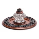 A 19TH CENTURY CARVED OAK CIRCULAR INK STAND with cut glass inkwell to the centre having a floral