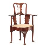 A GOOD GEORGE II MAHOGANY CORNER CHAIR with shaped raised back and fret cut vase-shaped splats, wide