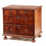 A WILLIAM AND MARY FIGURED WALNUT CHEST OF DRAWERS with quarter veneered top above two small and two
