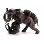 A 19TH CENTURY JAPANESE BRONZE depicting an Elephant and two Tigers, fitted with ivory tusks -