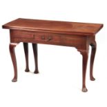 A GEORGE III MAHOGANY OVERSIZED COUNTRY HOUSE TEA TABLE with fold-over top above a central frieze
