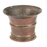 A LARGE 18TH CENTURY SEAMED COPPER MORTAR with flared rim and bound sides 36cm high 46cm diameter.