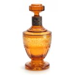 A LATE 19TH CENTURY BOHEMIAN SILVER MOUNTED AMBER GLASS DECANTER AND STOPPER the panelled urn-shaped