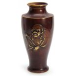 A JAPANESE MEIJI PERIOD BRONZE VASE with relief moulded portrait of a Buddha 25cm high.