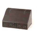 A LATE 17TH CENTURY OAK DESK BOX with angled fall having strap iron hinges, above a floral flower