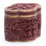 A 19THCENTURY CHINESE CINNABAR AND ENAMELLED BRASS SHAPED OVAL BOX with finely detailed figural