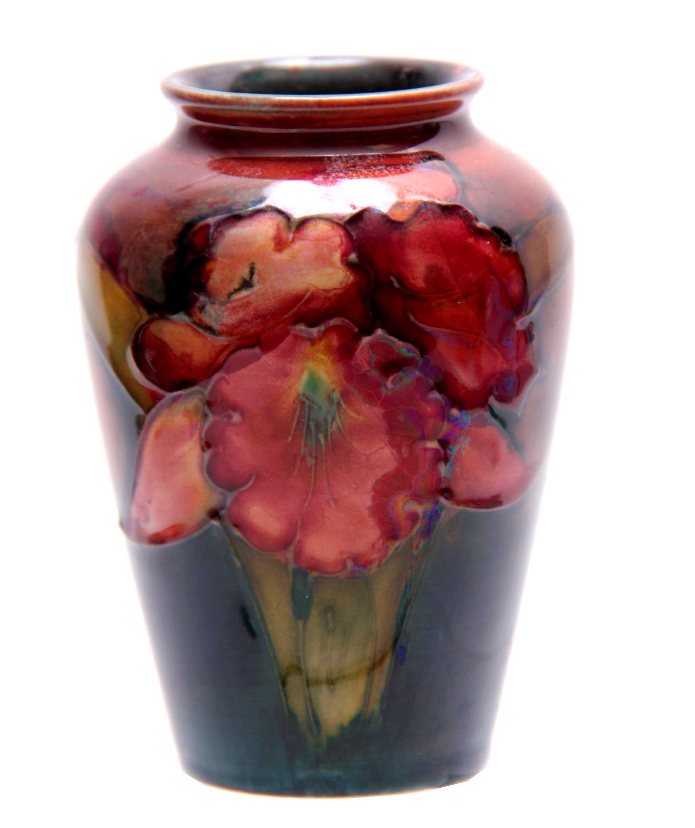 A SMALL 20TH CENTURY FLAMBE MOORCROFT VASE decorated with orchids 9cm high.