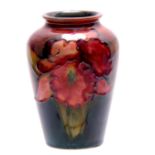 A SMALL 20TH CENTURY FLAMBE MOORCROFT VASE decorated with orchids 9cm high.