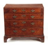 A GEORGE I WALNUT CHEST OF DRAWERS with a caddy moulded top above four graduated drawers fitted with