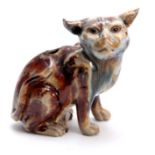 A 19TH CENTURY TREAKLE GLAZED SLIPWARE CAT 19cm high.