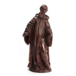 A 17TH CENTURY CARVED LIMEWOOD FIGURE OF A SAINT finely carved with a good patination 48cm high.