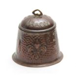 AN ARTS AND CRAFTS HAMMERED COPPER TOBACCO JAR AND COVER with floral decoration and Fleur-de-lis -