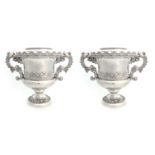 A PAIR OF REGENCY SILVER PLATED OLD SHEFFIELD WINE COOLERS having urn-shaped bodies, side handles