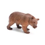 A 19TH CENTURY SWISS BLACK FOREST CARVED BEAR IN THE MANNER OF HUGGLAR with glass eyes 22.5cm wide.