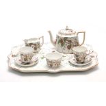 A 20TH CENTURY CONTINENTAL PORCELAIN TEA FOR TWO SET comprising of a tray, two cups and saucers,