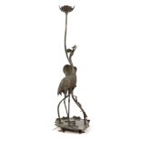 AN ART NOUVEAU GREEN PATINATED BRONZE STANDARD LAMP depicting a Crane stood on a large Lilly pad