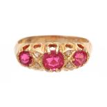 A 9CT GOLD AND RUBY SET RING having three ruby stones in claw settings hallmarked 9ct gold