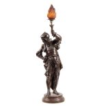 AN EARLY 20th CENTURY PATINATED BRONZED METAL FIGURAL LAMP modelled as a knight holding a torch with