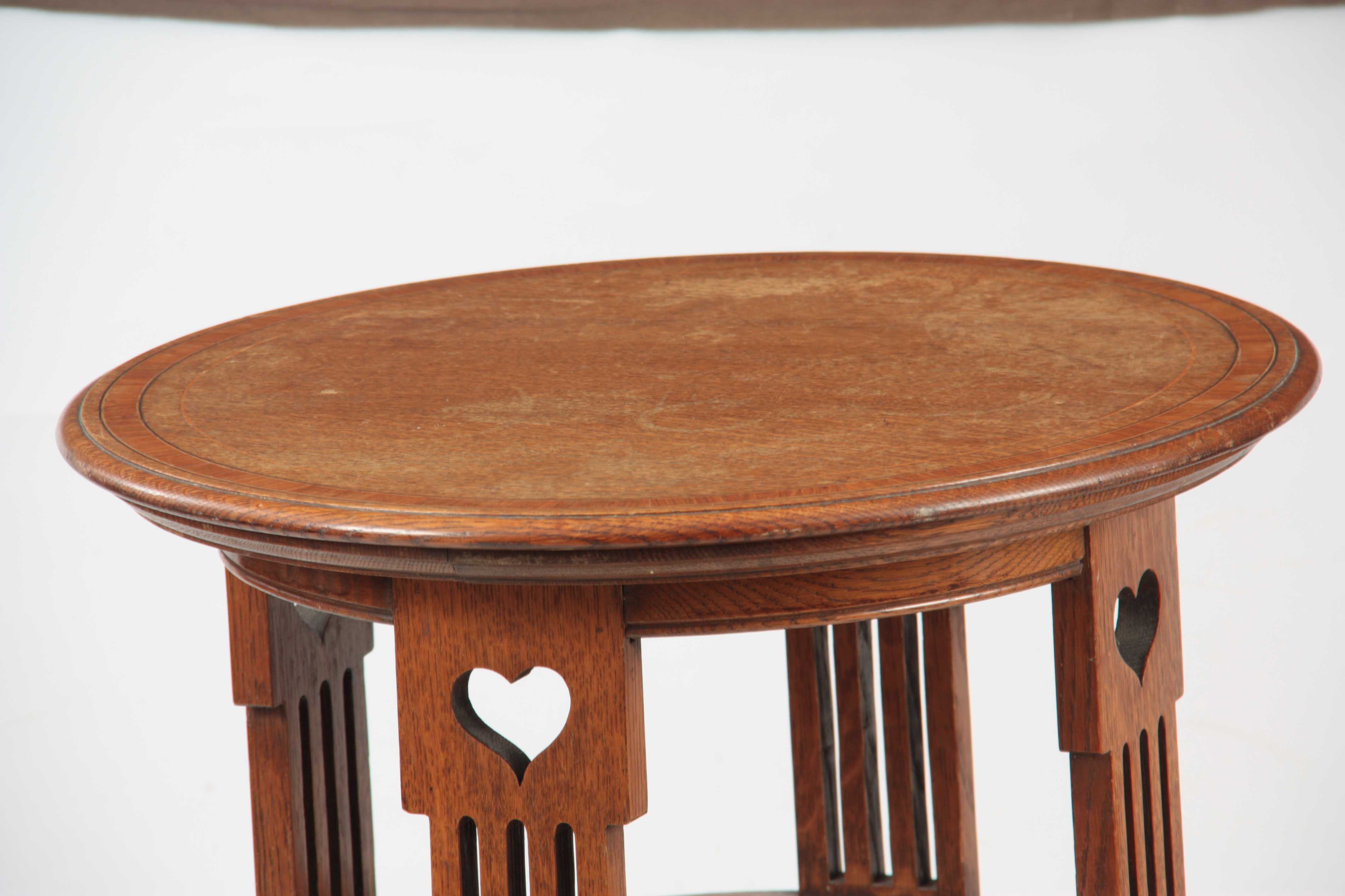A LIBERTY STYLE ARTS AND CRAFTS OAK OCCASIONAL TABLE having a circular top with kingwood - Image 2 of 4