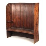 A GEORGE III BOWED ELM TAVERN SETTLE having plank back and thick-cut seat joined by enclosed sides
