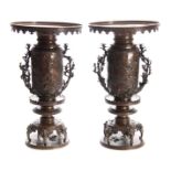 A LARGE AND IMPRESSIVE PAIR OF MEIJI PERIOD JAPANESE BRONZE VASES with sconce style rims decorated