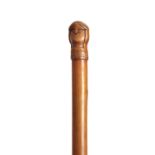 AN EARLY 20TH CENTURY SCANDINAVIAN HARDWOOD WALKING STICK carved with a two-faced figural handle