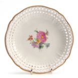 A LATE 19TH CENTURY CIRCULAR KPM DISH with pierced edges and painted floral decoration 20cm