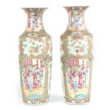 A LARGE PAIR OF 19th CENTURY CHINESE CANTON VASES decorated in the Famille Rose palette depicting