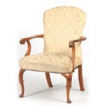 A GEORGE I STYLE WALNUT UPHOLSTERED ARM CHAIR with arched shaped back above sweeping scrolled